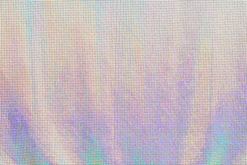 Rainbow textile fabric shining in neon colors. Iridescent texture background