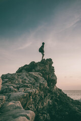 silhouette of a person on a rock