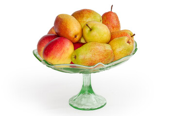 Pears and red apples in vintage glass vase for fruits