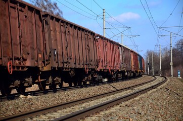 Freight railway cars running on electrified railway track, Czech Republic, Europe.