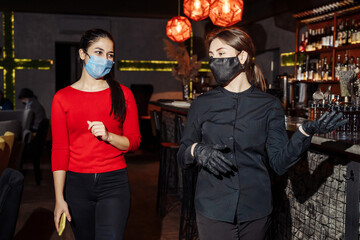 New normal. New rules for visiting cafes and restaurants during the coronavirus pandemia covid-19. Maximum protection during communication with customers - a mask and gloves for employees