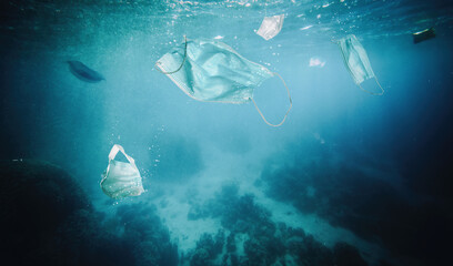 surgical mascheine floating in the sea.