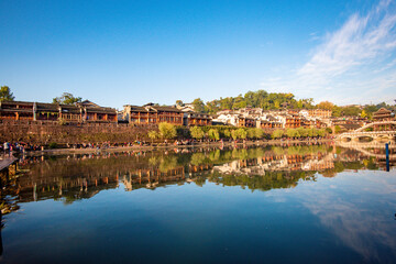 Fototapeta premium the river, the boat, stone bridge and the old houses at ancient phoenix town in the morning at Hunan, China. 