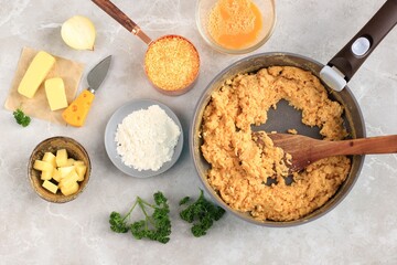 Risotto,  Main Ingredients for Making Cooking Arancini on a White Grey Marble Background. Cheese, Rice, Milk, Egg, Carrot, Parsley, Butter, Garlic, Bread Crumb, and Parmesan