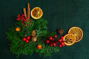 Beautiful New Year and Christmas composition on a background of green burlap, stylish. Flat lay, copy space, top view
