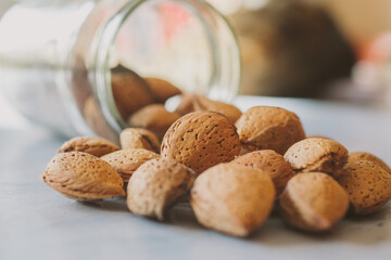 Almonds in a jar on wooden rustic table as background. Close up view.	