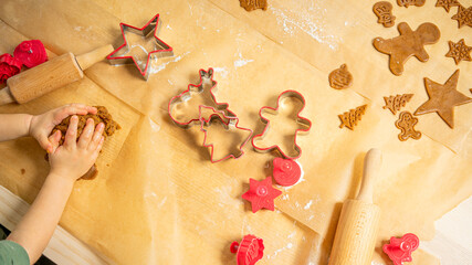 Youg boy kneading dough. getting ready for Christmas, baking ginger bread.