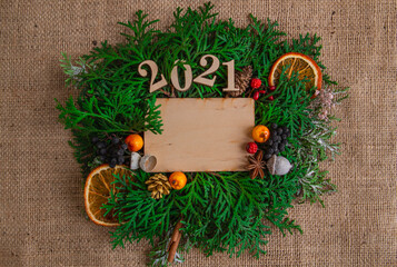  New Year and Christmas composition 2021, greeting card on a burlap background, stylish. Flat lay, copy space, top view