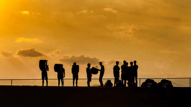 drum line rehearsing at sunset at the edge of the stadium