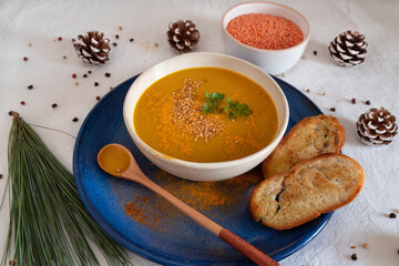 Orange soup in a bowl, pumpkin, carrot or coral lentils
