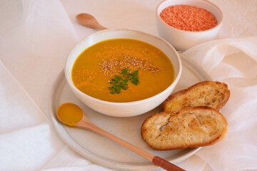 Orange soup in a bowl, pumpkin, carrot or coral lentils
