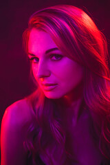 young woman under colored light