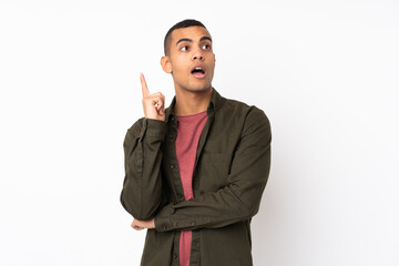 Young African American man over isolated white background thinking an idea pointing the finger up