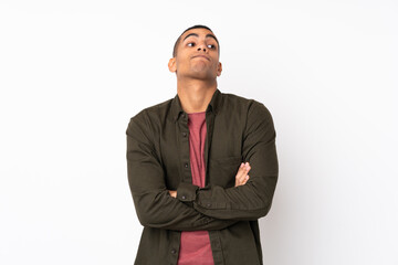 Young African American man over isolated white background making doubts gesture while lifting the shoulders