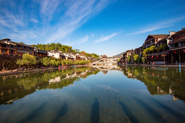 Fototapeta premium the river, the boat, stone bridge and the old houses at ancient phoenix town in the morning at Hunan, China. 