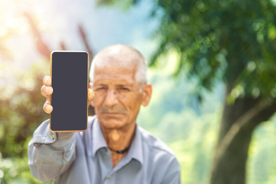 Indian Rural Old Man Showing Mobile Phone