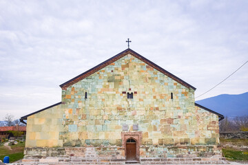 Fototapeta premium Bolnisi sioni cathedral building colorful wall bricks with cross on top in a countryside of Georgia.