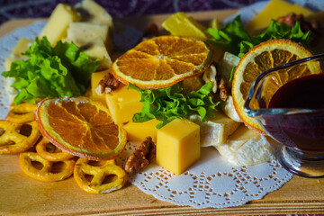 Still life of cheese and dried orange as an appetizer for wine