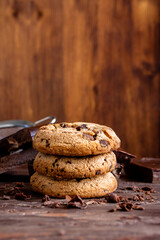 Organic food snack tasty sweet dessert milk dark chocolate chip salt cookie closeup piece fruit orange raspberry hazelnut nuts cinnamon on cocoa cacao powder wooden table for new year Christmas gift
