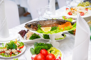 baked trout,  fish on the Banquet table