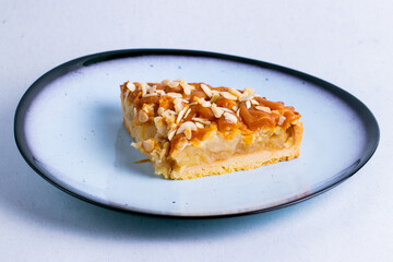 Apple pie in a ceramic plate isolated on a white background close up.