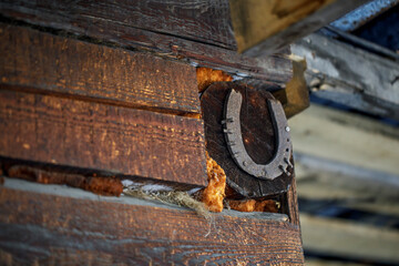 An old horseshoe on the wall of a rural house. The symbol of good luck in Russia.