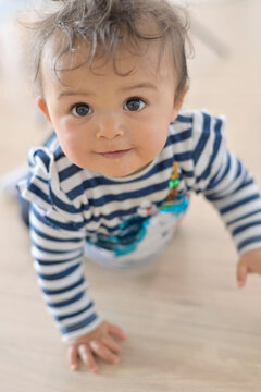 Cute 8-month-old baby girl crowling on all four