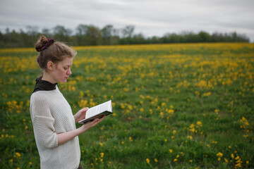girl reading a book in nature