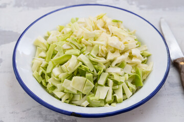 fresh cabbage on white dish on ceramic background
