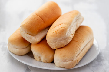 bread for hot-dog on white dish