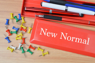 Selective focus of pinboards, pens and  pencil case written with text NEW NORMAL. Education and...