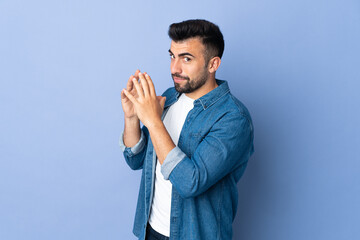 Caucasian man over isolated blue background scheming something