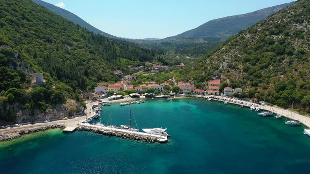 Aerial drone video of picturesque small fishing village of Frikes a safe anchorage for sail boats and yachts in island of Ithaki or Ithaca, Ionian, Greece