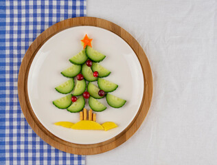 Christmas tree made from cucumber. a fun idea for a baby snack. on a white background.
