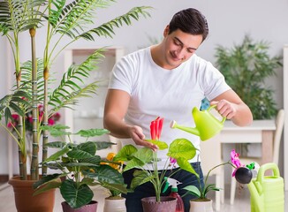 Young man in gardening concept at home