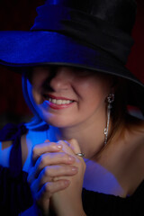 Portrait of fat plump chubby middle-aged woman with hat and black dress. Model looking as lady posing in studio.