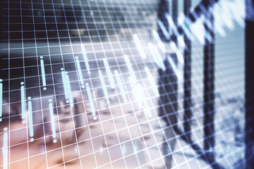 Blurred modern workplace interior with glowing stock charts