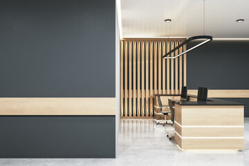 Luxury office lobby with wooden reception desk and blank gray wall.