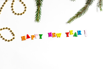 Bright Christmas frame made of spruce, gold jewelry and the inscription 