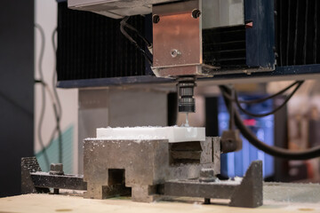 Turning milling machine cutting white acrylic artificial stone workpiece at factory, exhibition. Stoneworking, engraving, industrial, equipment, production, technology, manufacturing concept