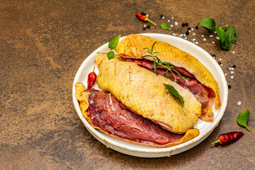 Raw duck breasts with fresh greens and fragrant spices