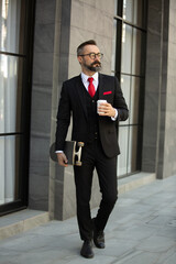 Bearded hipster businessman holding coffee cup portraits.