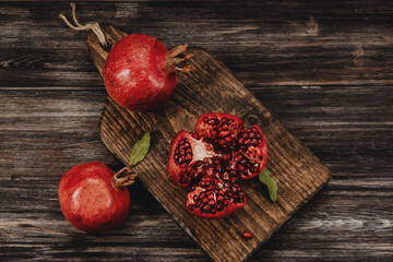 three red grenades on a wooden Board in a rustic style