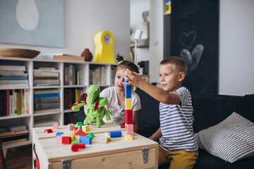brother and sister playing with cuber at home