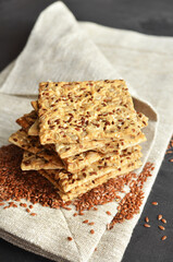 Multigrain crunchy crispbread on a dark concrete background.