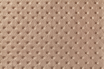 Texture of brown leather background with capitone pattern, macro.