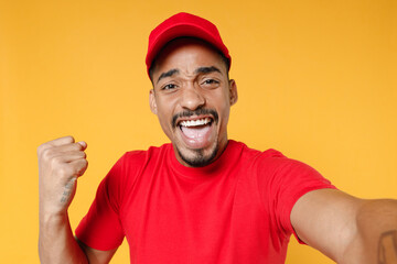 Close up fun delivery employee african man in red cap blank print tshirt work courier service...