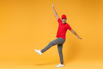 Fototapeta na wymiar Full length delivery employee african man 20s in red cap blank print t-shirt uniform workwear work courier dealer service during quarantine covid-19 virus concept isolated on yellow background studio.