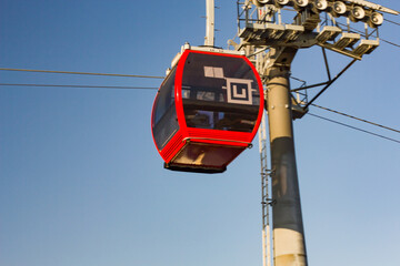 Suspension, cable car, funicular cab in red.