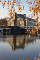 A large stone bridge with a road for cars.